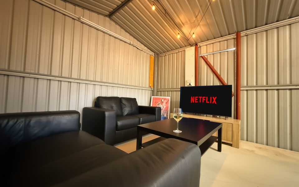 Enjoy the games room, complete with a Smart TV, couches, dartboard, and table tennis.