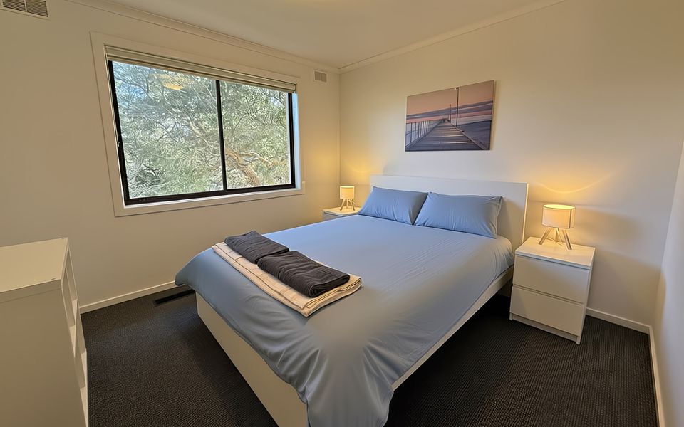 Bedroom two with Queen bed, ducted heating and robe.