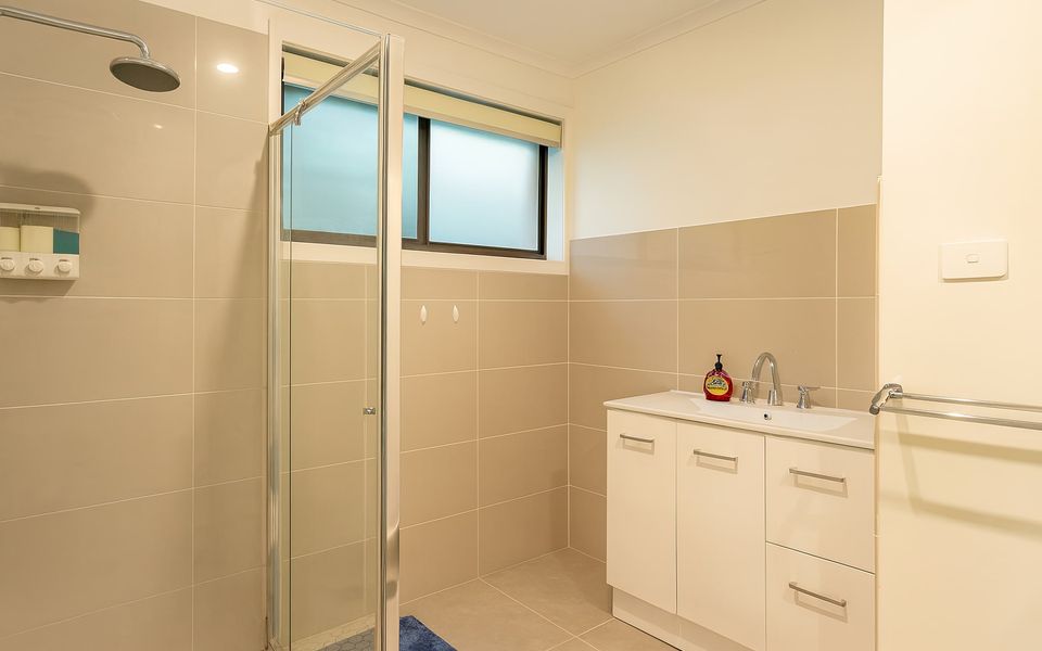 Family bathroom featuring a shower and vanity, there is a separate powder room.