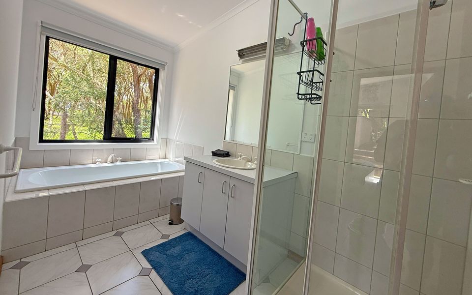 The family bathroom includes a shower, bath, and vanity.