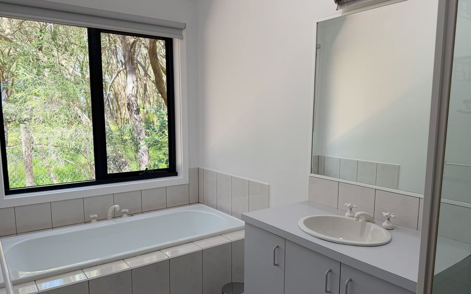 Family bathroom featuring a shower, bath and vanity.