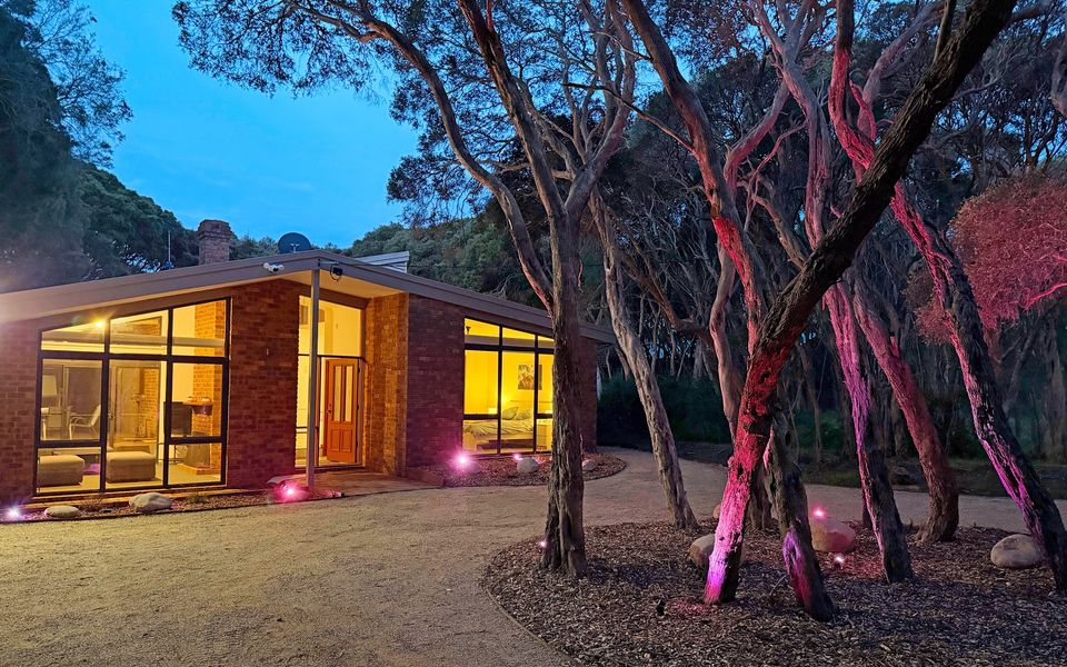Moonah Ocean with a private driveway and front garden with illuminated Moonah trees.