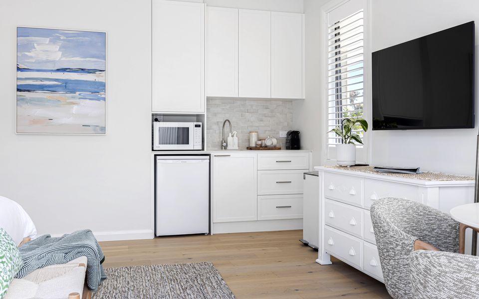 Kitchenette with microwave, mini fridge, toaster and Nespresso coffee machine