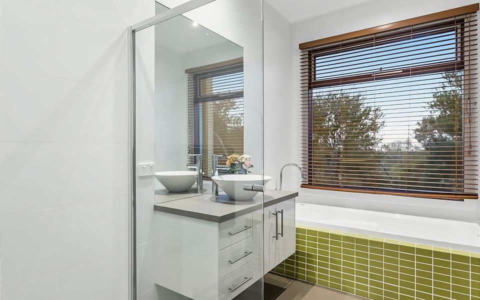 Main bathroom with bath and shower.