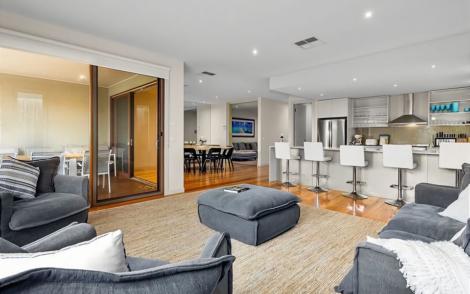 The main living area has a fantastic open kitchen with loads of counter space and highball stools to gather around while meals are being prepared.