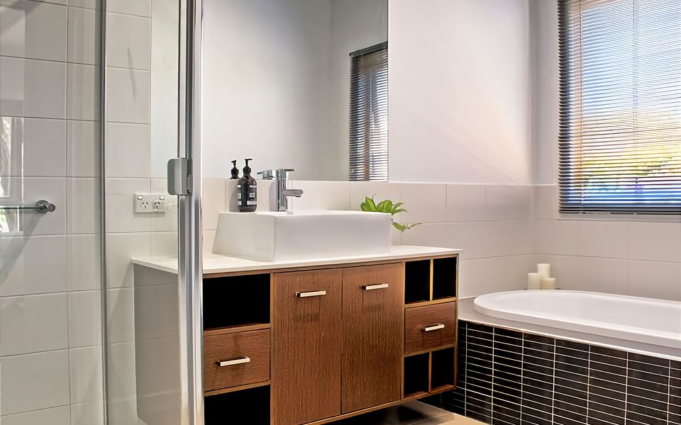 Main bathroom with shower, bath, vanity and separate toilet.