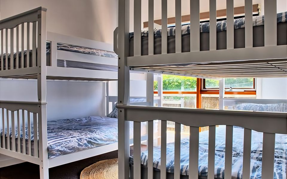 Relax in the cozy comfort of our inviting room furnished with two comfortable King Single bunk beds...