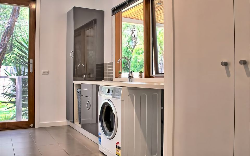 The laundry is equipped with washing machine and has access to the back yard and clothes line.