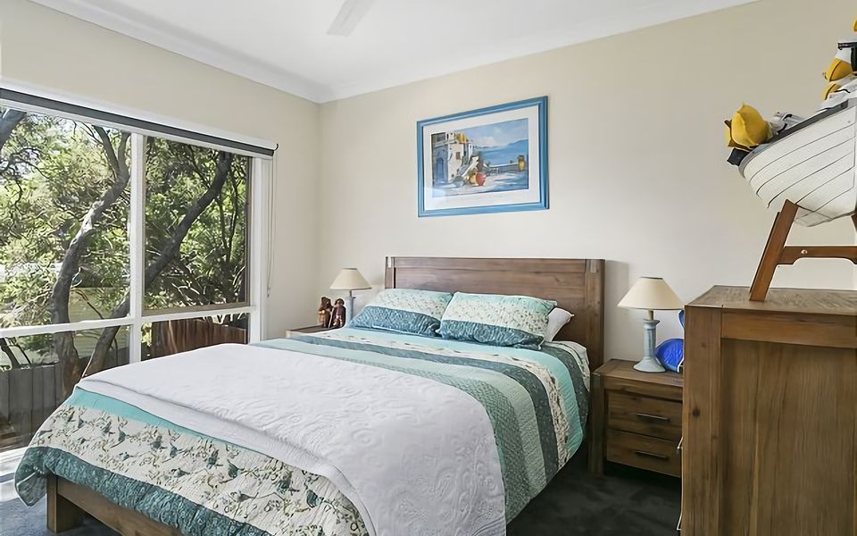Recharge in this tranquil bedroom with a queen bed.
