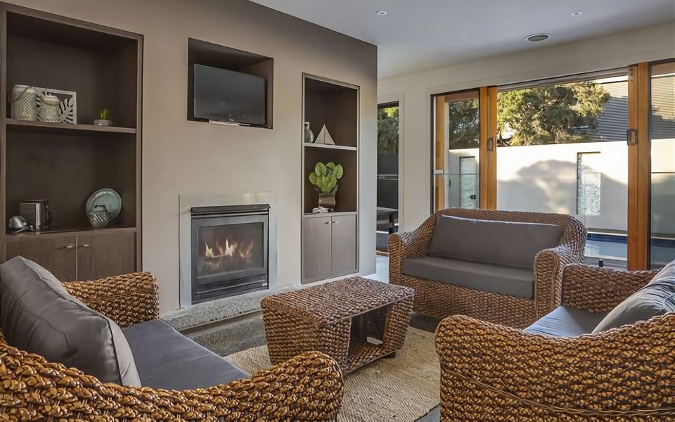 One of our delightful lounge rooms, adorned with a charming fireplace, provides the perfect ambiance for relaxation.