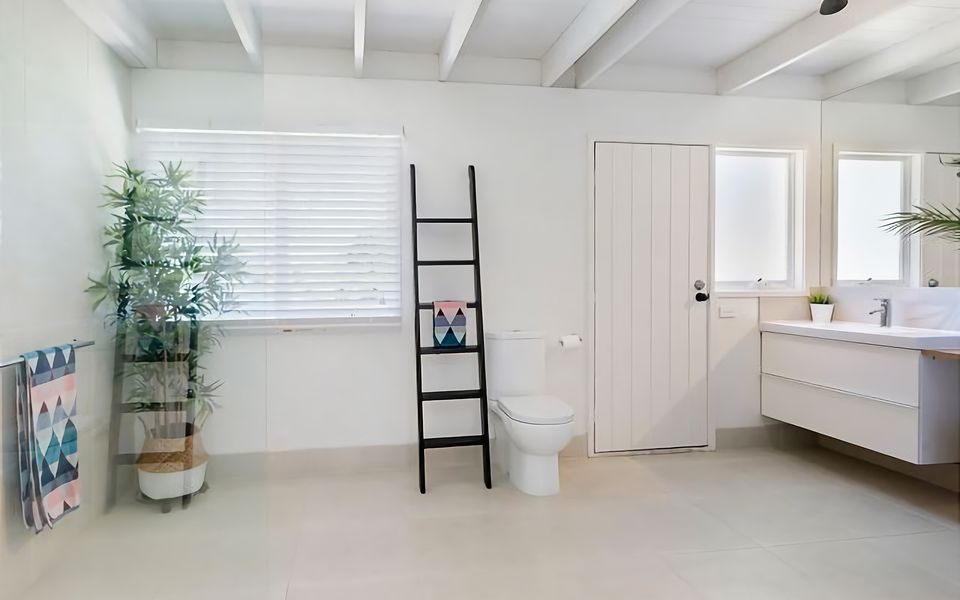 Family bathroom with shower, vanity, toilet and European laundry