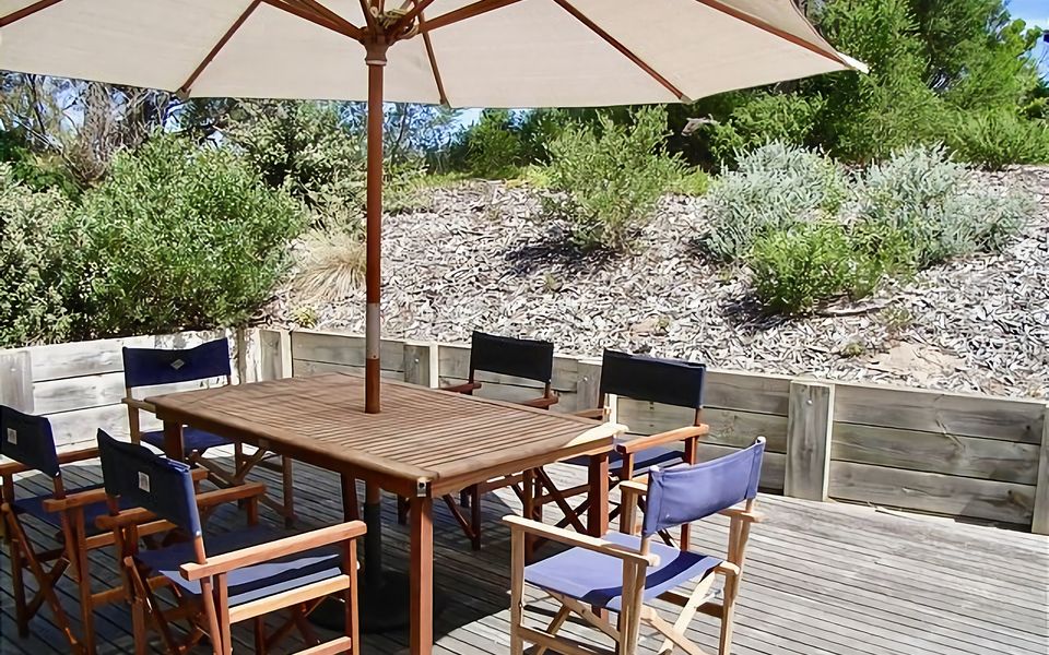 Spacious rear deck with BBQ, alfresco dining and shade umbrella.