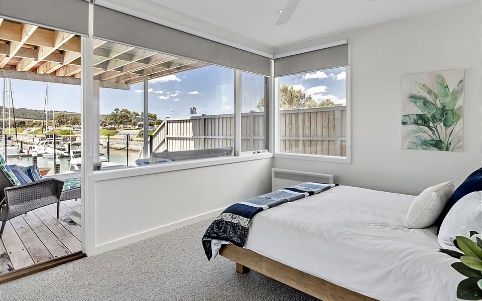 Queen bed bedroom with access to deck.