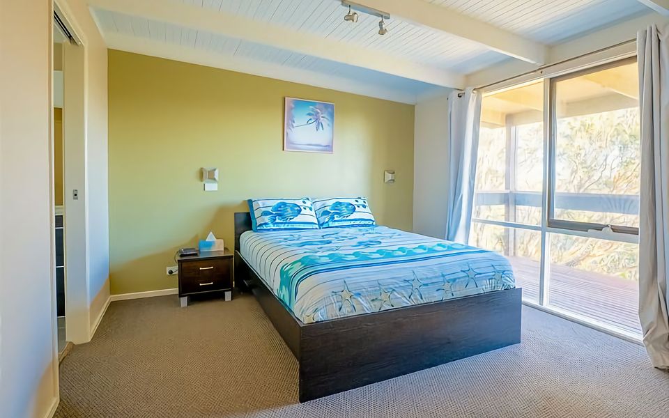 Master bedroom with Queen bed, which has access to the main bathroom with shower, vanity and separate toilet.