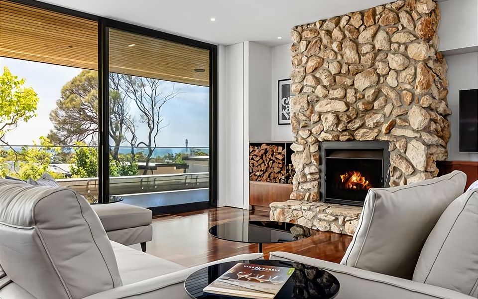 Stylish soft leather couches around the fireplace and flat-screen TV.
