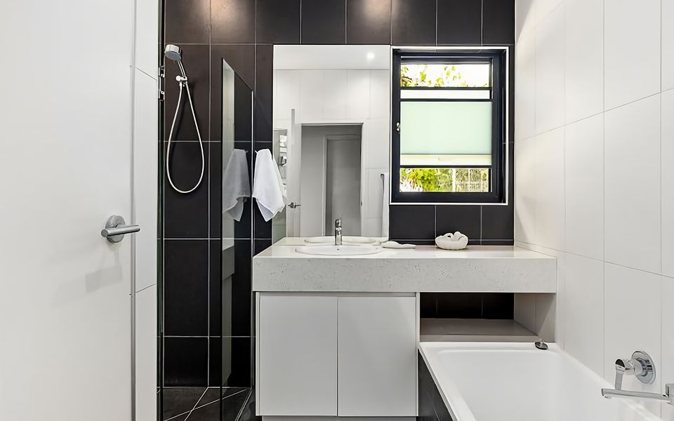 Downstairs bathroom with a deep bath, shower, vanity, and toilet.