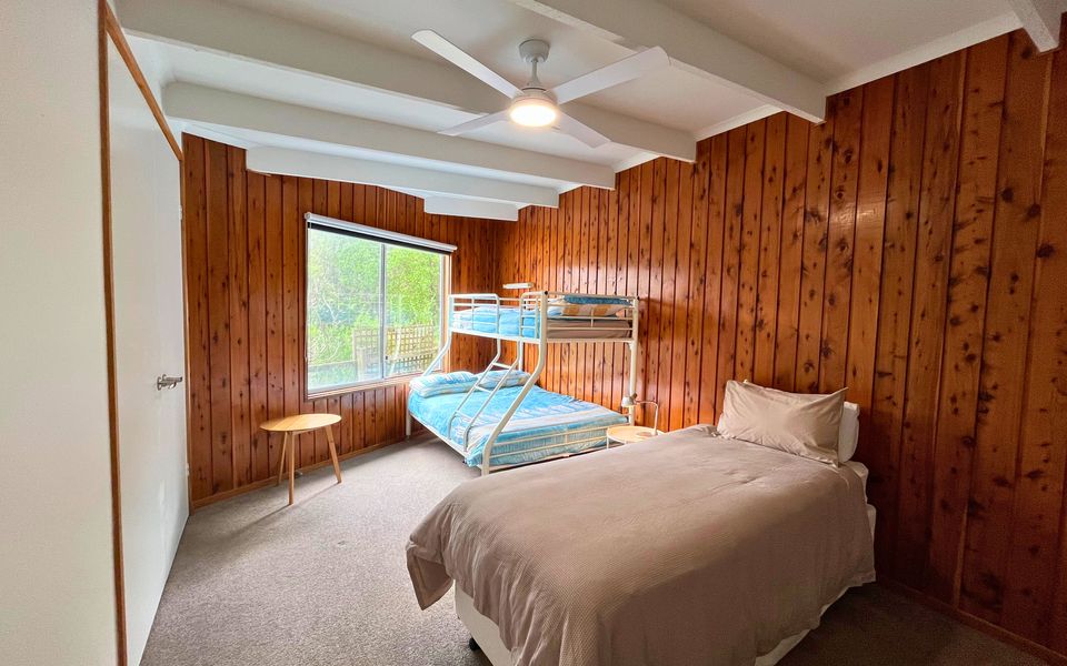 Bedroom two with tri bunk, single bed, wardrobe and ceiling fan