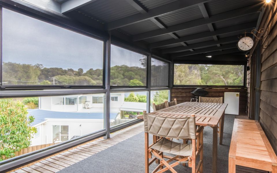Balcony accessed through large sliding doors. There is the option to fully enclose the space with slide-down side screens.