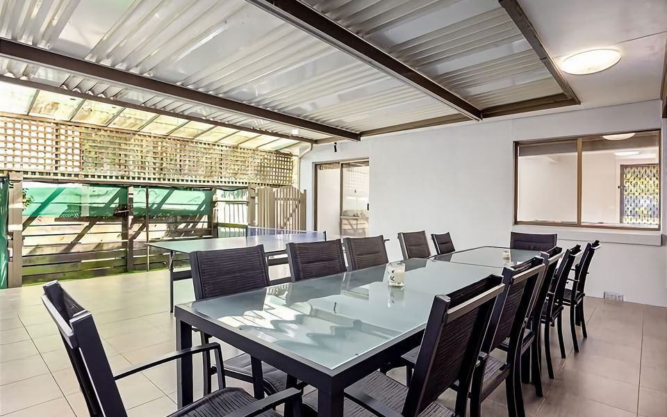 undercover entertaining area with outdoor furniture and table tennis table.