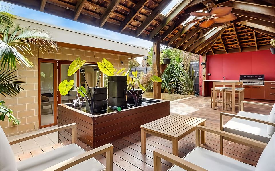 Out the back beneath the enormous timber pergola you'll enjoy a seating area around a pond, an outdoor kitchenette with gas BBQ cooking facilities and high ball table and chairs.