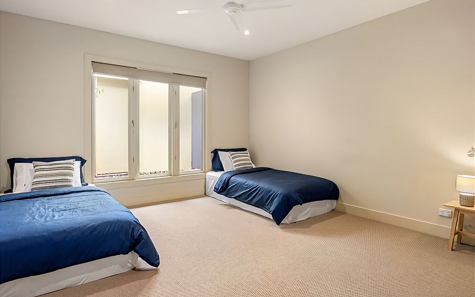 4th Bedroom with 2 x King Single Beds, 2 x King Single Trundles, and air conditioning.