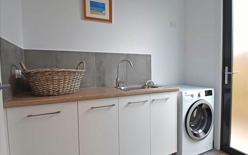 Laundry with front loader washing machine.