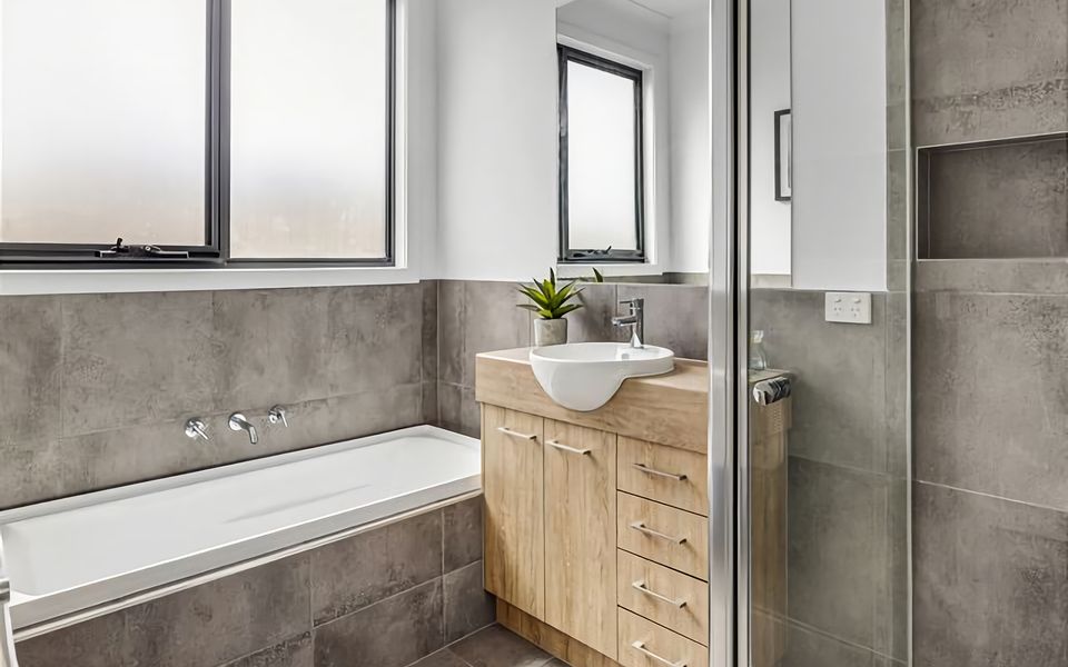 The main bathroom with shower and a bath.