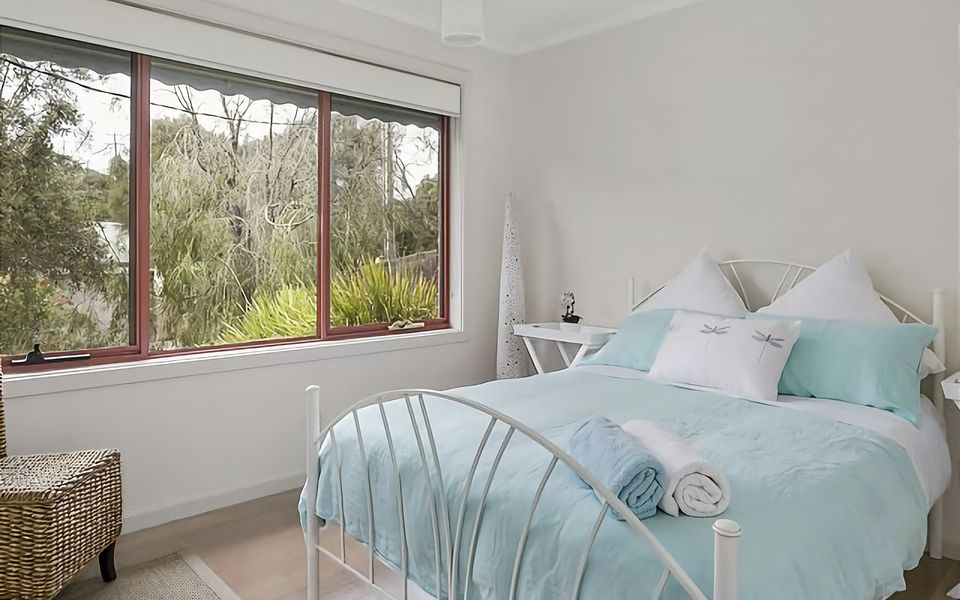 Recharge in this tranquil bedroom with a queen bed.