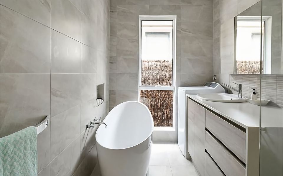 Main bathroom with bath shower and European style laundry.