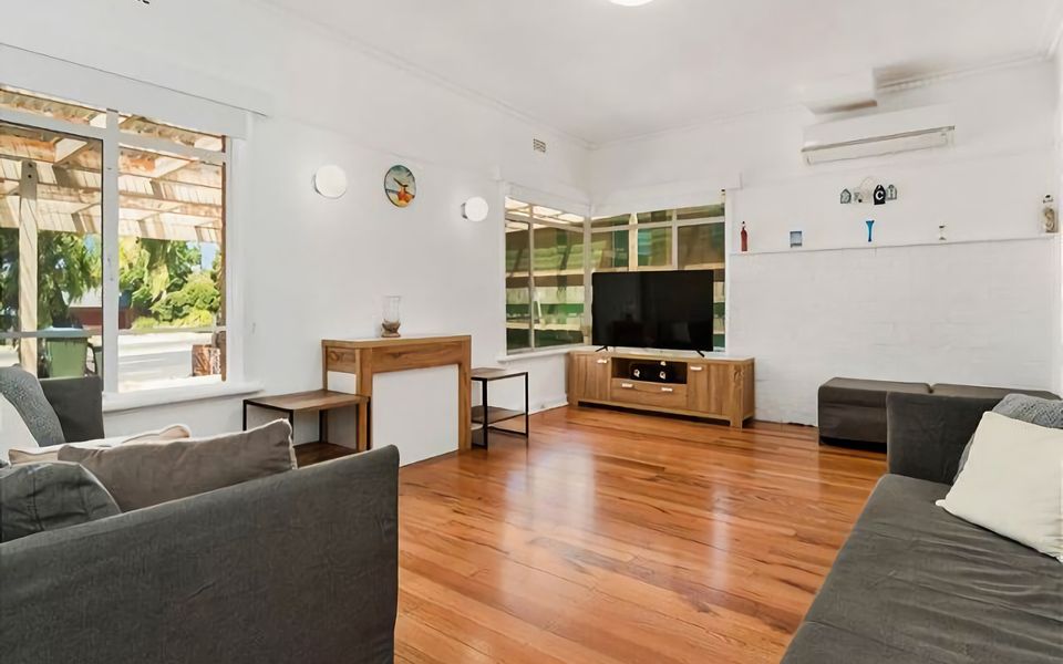 Step into our cozy lounge, featuring a comfortable seating area and TV.