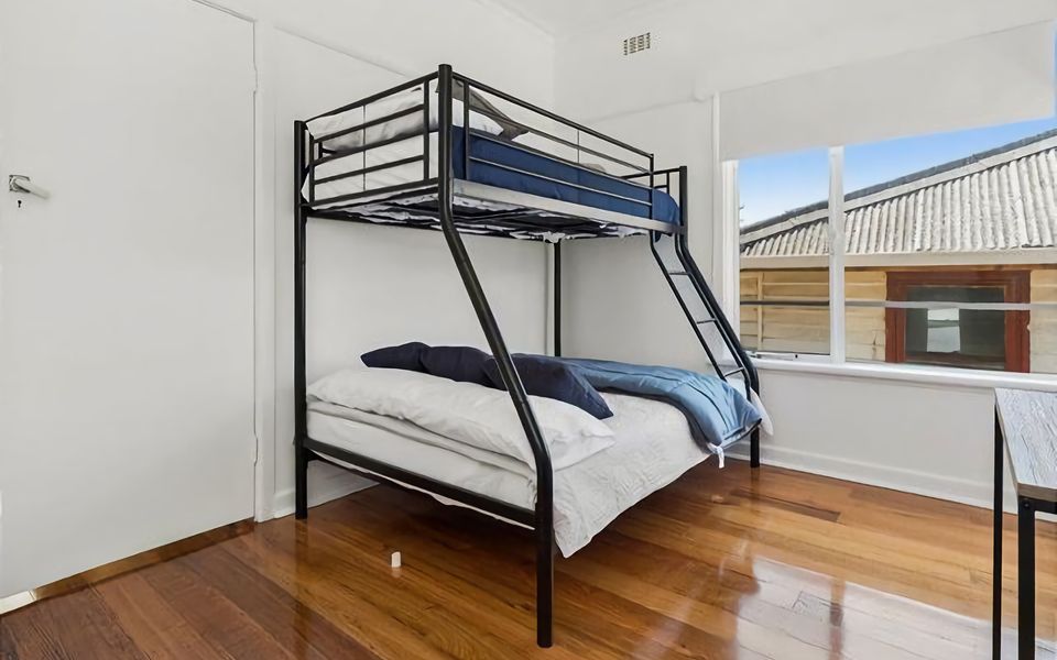 This spacious bedroom offers a Trilogy Bunk Bed (single over double)