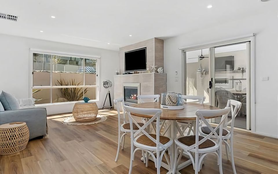 The dining area is tastefully designed, providing a charming setting for enjoying meals while being in close proximity to the cozy gas log fire and TV.