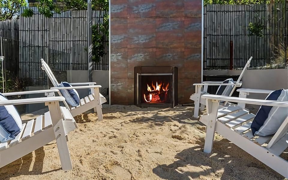 Relax and unwind by the cozy outdoor fireplace, nestled in the heart of our enchanting garden.