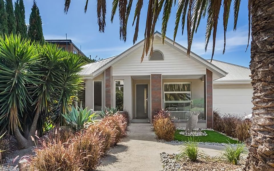 Your dream escape awaits! This image showcases the idyllic front facade of our vacation rental, nestled in a peaceful neighborhood, offering privacy and relaxation.