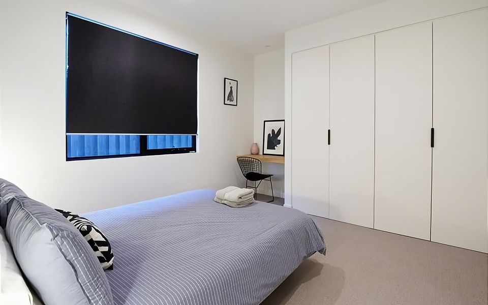 Bedroom with Queen bed and desk nook.
