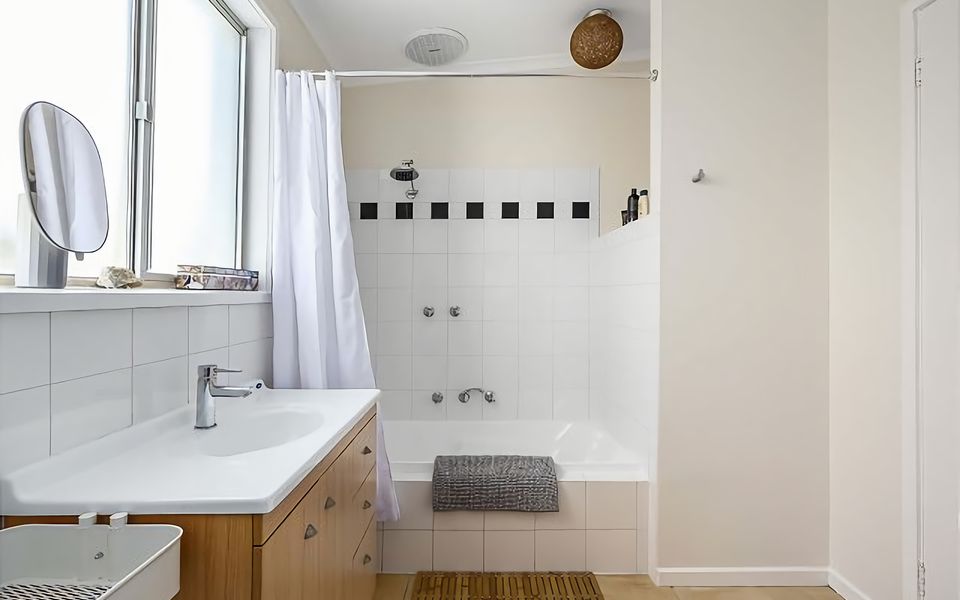 Bathroom with bath, shower and basin.