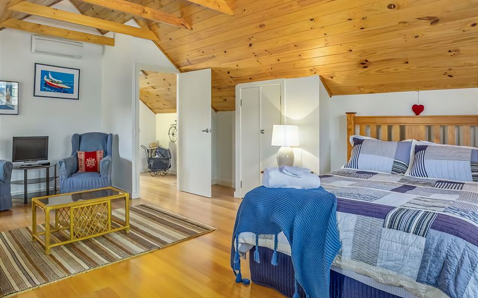 Enjoy the large spacious main bedroom with a Queen bed and sitting area.