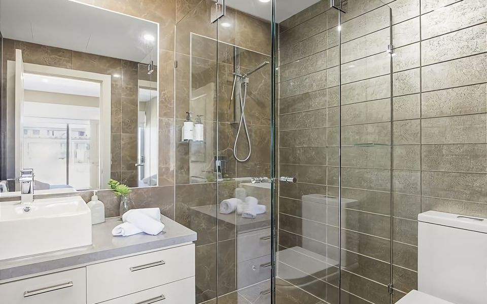 This beautifully designed space features modern fixtures and a clean, minimalist aesthetic, providing a tranquil oasis for your relaxation.