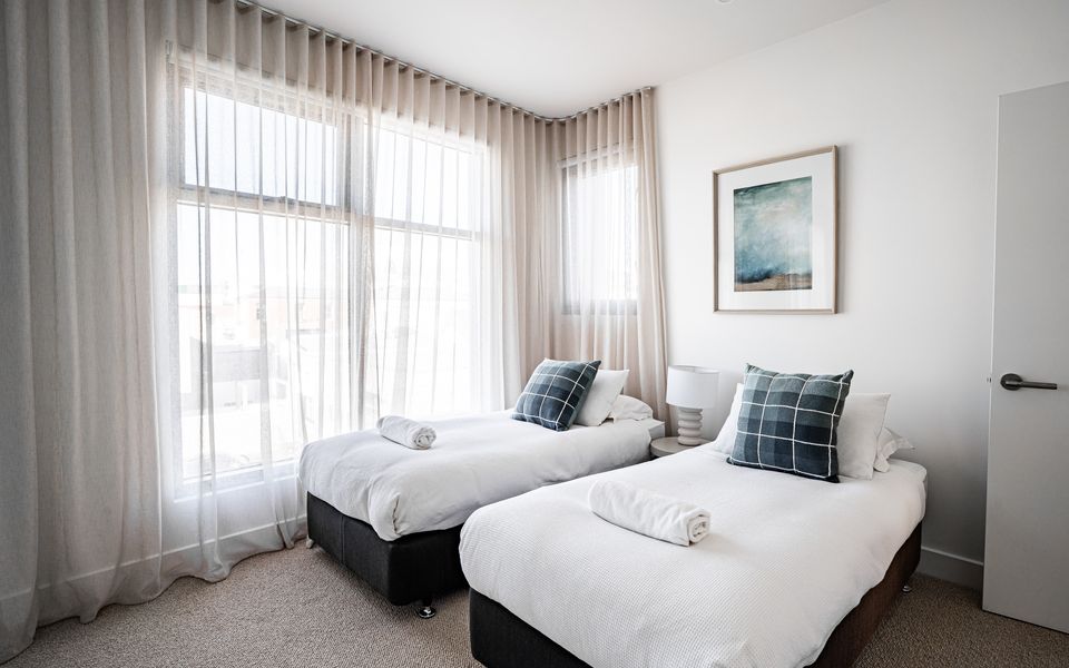 Second bedroom with single beds and TV