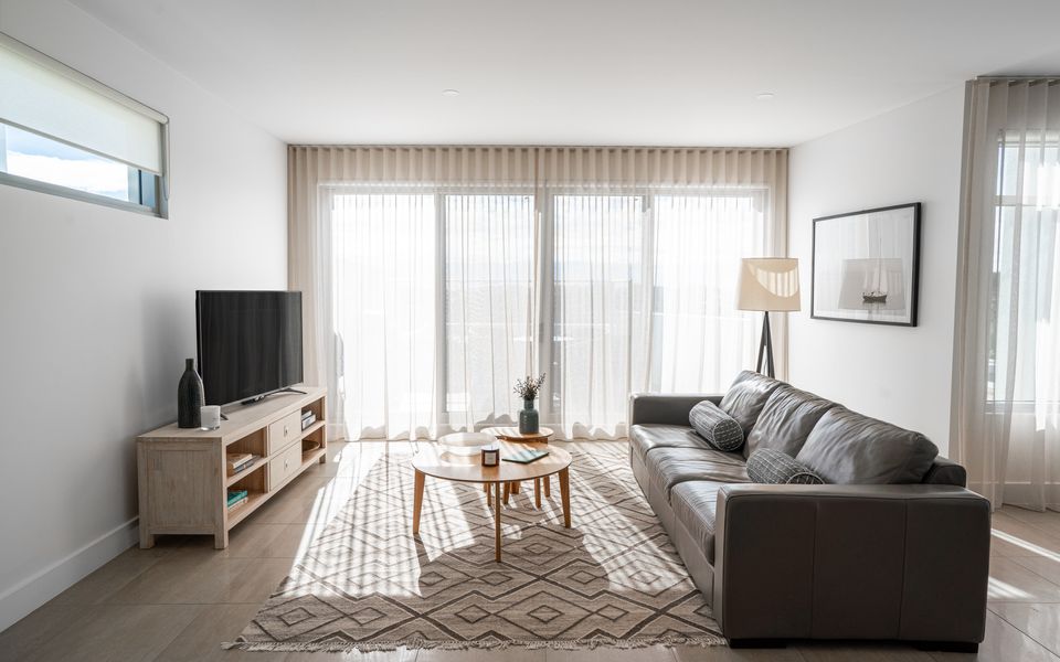 Living area with smart TV, and access to private balcony