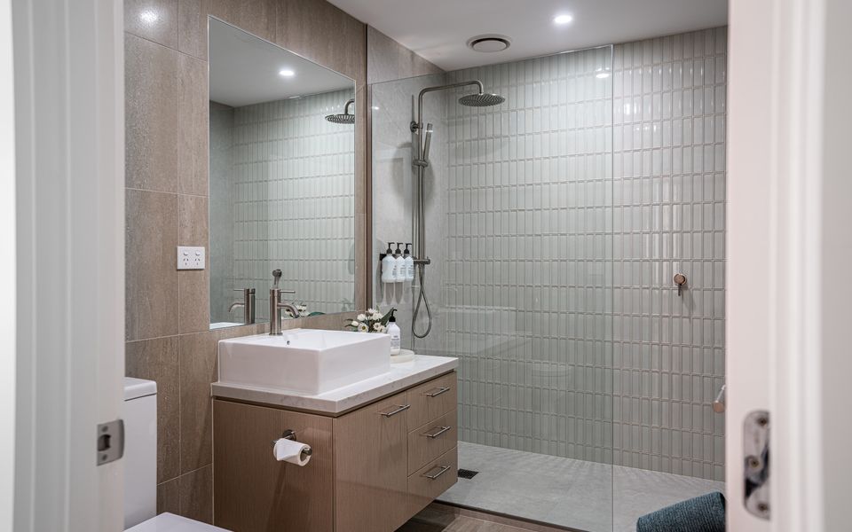 Family bathroom with spacious walk-in rainfall shower, vanity and toilet. Fresh linen provided.