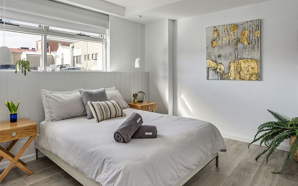 A spacious bedroom featuring a comfortable queen bed, perfect for a relaxing night's sleep.