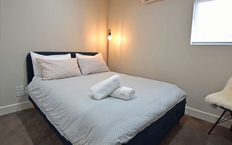 The minimalist decor and neutral tones create a serene atmosphere for a rejuvenating stay.