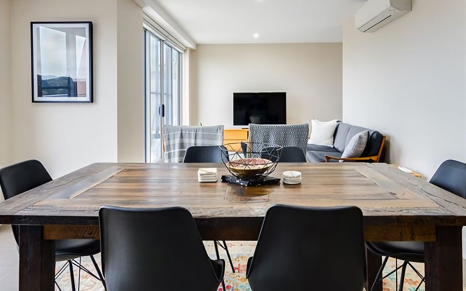 The perfect balance of comfort and sophistication in this well-appointed apartment, where a spacious dining table complements the inviting lounge area.