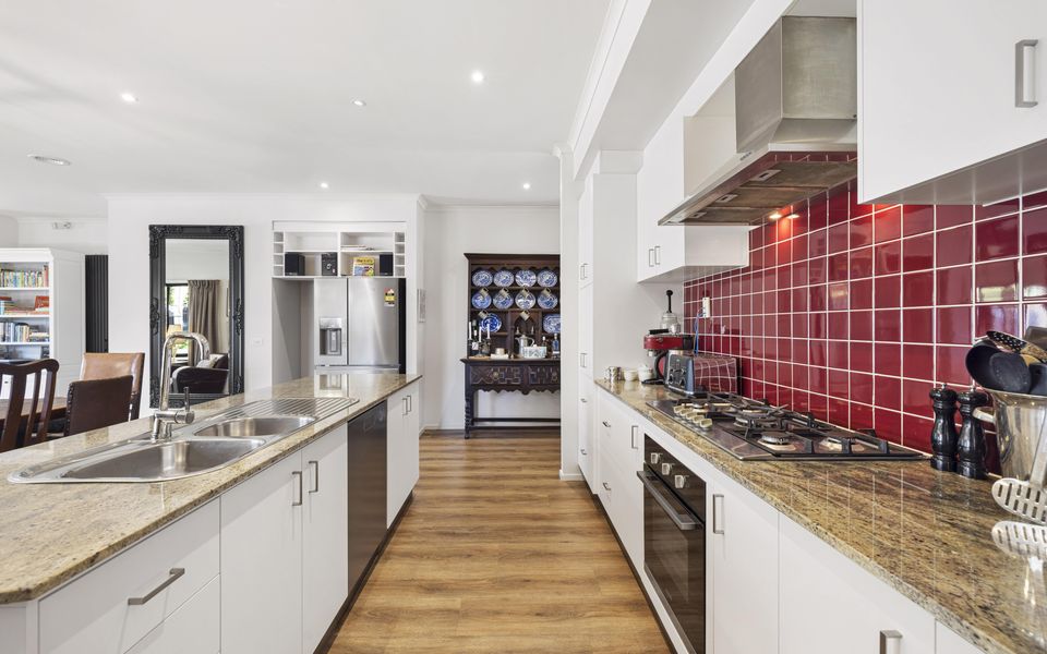 Open plan kitchen with stainless steel appliances.