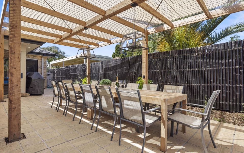 Outdoor dining for 14 under a shaded pergola