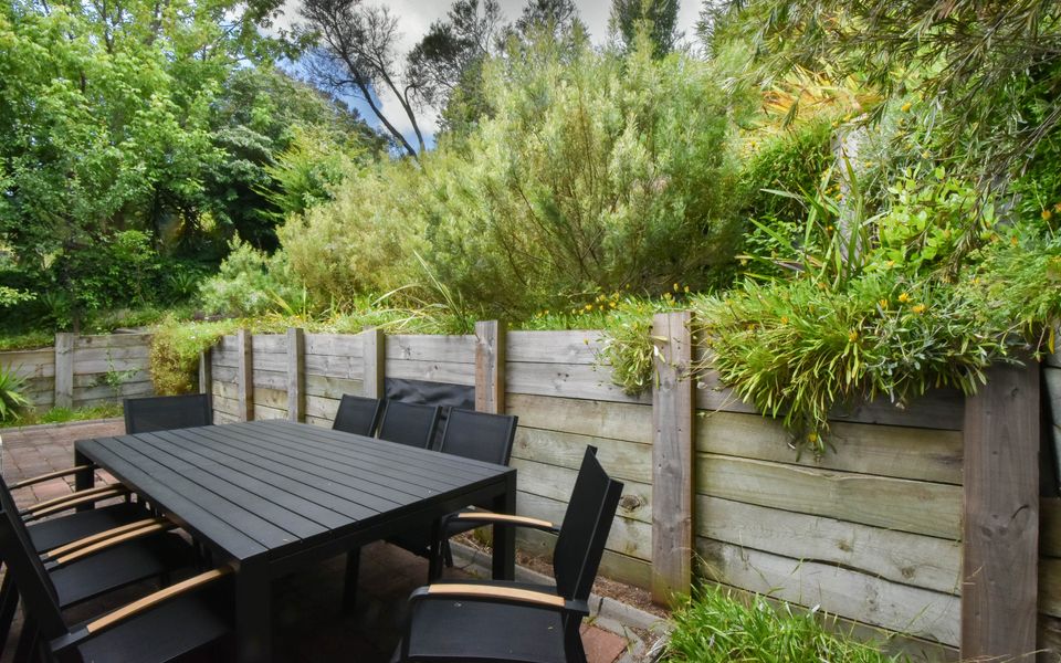 8 seat alfresco dining set on the patio in the backyard.