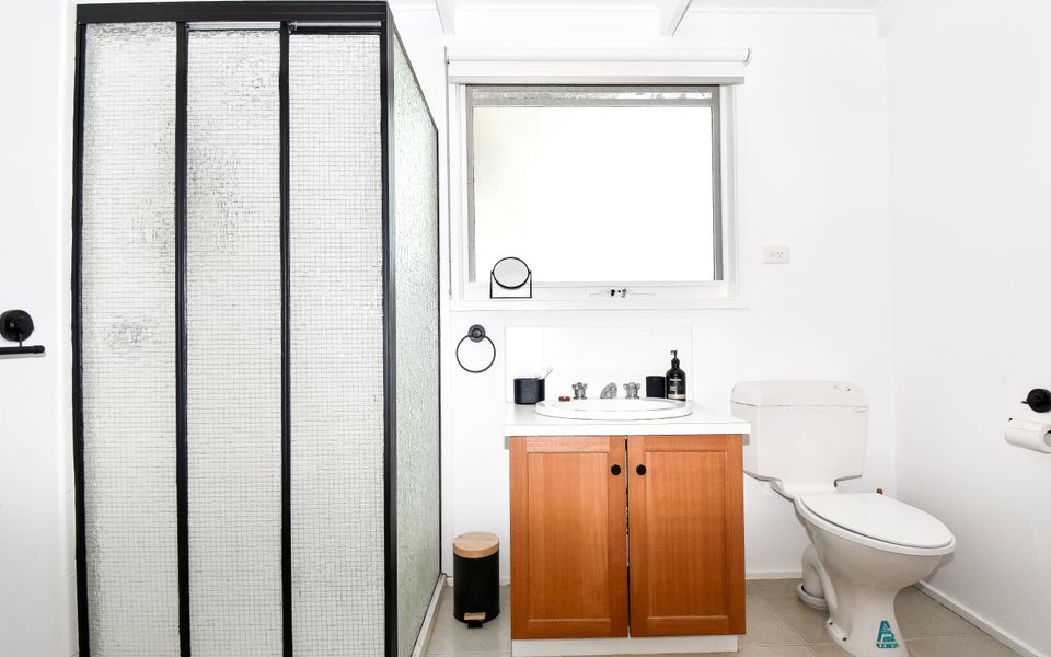 Main bathroom has a shower, hand basin and toilet.
