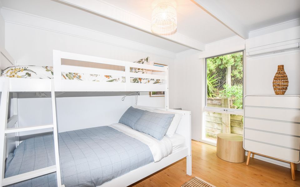 3rd Bedroom:.Tri-Bunk Bed, reverse-cycle AC, and chest of drawers.