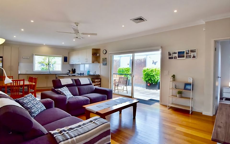 Lounge room with big screen TV and sliding door access to the terrace.